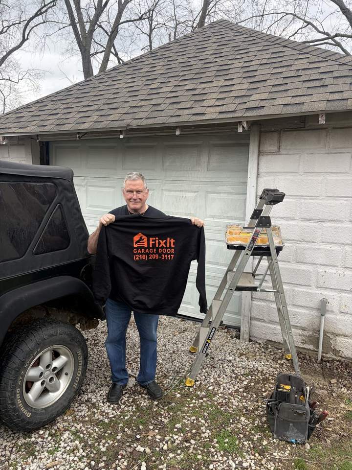FixIt Garage Door shirt beside repair equipment