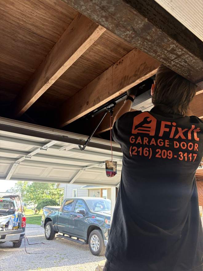 FixIt technician repairing a garage door