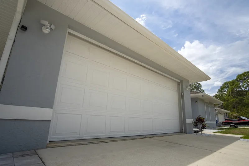 White sectional garage door on a residential driveway